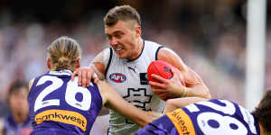 Patrick Cripps fends off two tacklers during the Blues’ win.