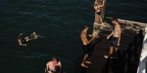 Swimmers enjoy one of the last dips of summer off the Coffs Harbour jetty in February.