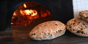 The wood-fired stove pumps out the signature puffy bread.