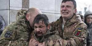 Ukrainian servicemen cry near the coffin of their comrade Andrii Trachuk during his funeral service in Kyiv last month.