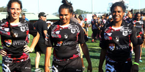 Three players from the victorious Redfern All Blacks women’s team walk off the field after the 2014 Koori Knockout final. 