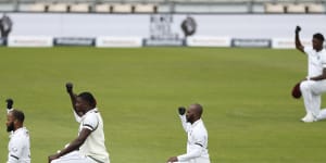 West Indies'captain Jasion Holder,centre,and teammates take a knee before the start of the Test match between England and West Indies at Southampton.