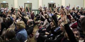 Attendants at a Stop WestConnex meeting at the Balmain Town Hall demonstrate the local opposition to the project. 