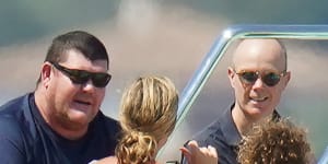 A bulkier James Packer with friends on his yacht in St Tropez in July last year.