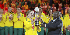 Australian captain Liz Watson collects the World Cup trophy.