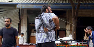 A man reacts at a site damaged by what activists said was an air strike by forces loyal to Syria's President Bashar al-Assad on a vegetable market in Idlib on Tuesday.