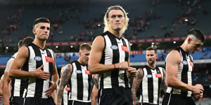 The Magpies looking dejected after losing their round one AFL match against the Sydney Swans at the MCG on Friday night.