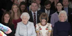 Queen Elizabeth sitting between Vogue editor Anna Wintour and her dressmaker Angela Kelly at a London Fashion Week show.
