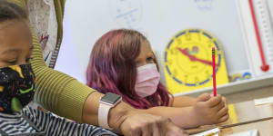 Primary school students wear masks in class at a school in Oakland,California. 