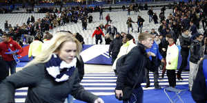 Spectators invade the pitch after the match.