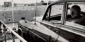 Robert Menzies watches the footy from his Bentley,parked on a specially built ramp in Melbourne,1972. 