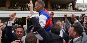 Jockey Damien Oliver is mobbed by winning owners after Steel Prince's narrow win on Saturday.