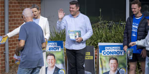 Liberal candidate,Nathan Conroy,greets voters alongside deputy Liberal leader Sussan Ley at a polling booth in Carrum Downs.
