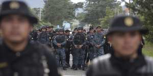 Guatemalan police block the road near Esquipulas,Guatemala on Monday.