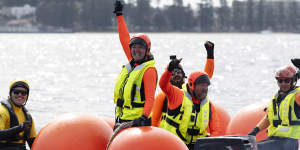 Rescuers celebrate after the whale they had just freed turned and swam for the open sea.