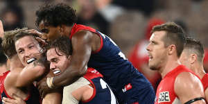 Melbourne has won its first eight games for the first time since 1965 after holding off the Swans.