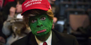 A man wearing face paint to resemble Pepe the Frog ahead of a rally for President-elect Donald Trump in 2016.