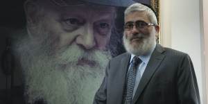 'Diamond Joe'Gutnick in front of a painting of Rabbi Menachem Mendel Schneerson,the last Lubavitcher Rebbe.