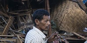 A man looks on at homes destroyed after air and artillery strikes in Mung Lai Hkyet displacement camp,in Laiza,Myanmar,in October last year. 