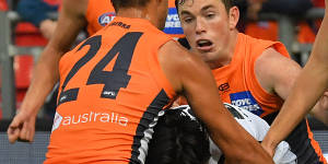 Carlton's Zac Fisher gets taken down by GWS'Matt De Boer.