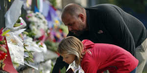 Mourners lay flowers on a wall at the Botanical Gardens in Christchurch,New Zealand.