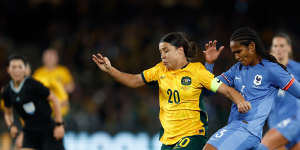 Australia’s Sam Kerr and France’s Wendie Renard compete for the ball.