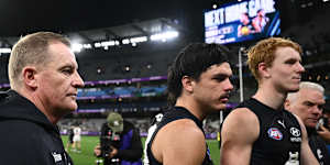 Voss and Hollands (centre) leave the MCG after the loss to Collingwood on April 16.