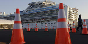 A security guard stands near the quarantined Diamond Princess cruise ship.