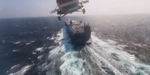 A Houthi helicopter approaches a cargo ship in the Red Sea as the rebels threaten to seize vessels owned by Israeli companies.