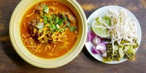 Khao soi curried noodle soup with chicken,a popular northern Thai dish. 