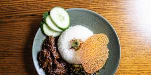 Beef cheek rendang topped with a lacy cracker made from kremes,a crunchy topping of chicken stock and seasoned flour.