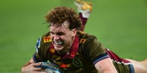 Tim Ryan of the Reds scores a try against the Blues at Suncorp Stadium on Saturday.