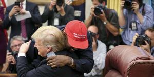 Rapper Kanye West hugs U.S. President Donald Trump during a meeting in the Oval office of the White House on October 11,2018 in Washington,DC..