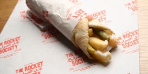A wrap filled with hot chips,toum (garlic sauce) and pickles.