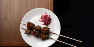 Char-grilled lamb “firepops” are spiced with sesame and cumin dukkah.