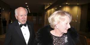 John and Janette Howard arrive at the former prime minister’s 80th birthday party at the Australian Club in 2019.