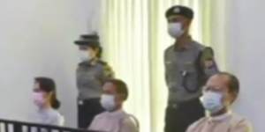 Deposed Myanmar leader Aung San Suu Kyi,left,was shown on TV sitting in court.