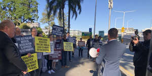 Katter’s Australian Party MP Nick Dametto speaks to protesters outside the Queensland Parliament,while fellow KAP member Shane Knuth watches on.