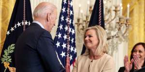 Carlson and U.S. President Joe Biden shake hands during an event for the signing of the “Ending Forced Arbitration of Sexual Assault and Sexual Harassment Act of 2021” into law.