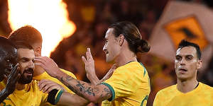 Awer Mabil celebrates his long-range winner with Socceroos teammates.