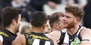 Trent Cotchin and Taylor Adams test the durability of each other’s jumpers out. 