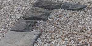 Old bluestone edging has been paired with gravel.
