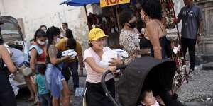 People collect food donated by aid groups in Rio de Janeiro,Brazil,on Wednesday. 