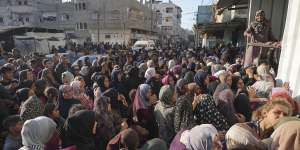 A crowd gathers in front of a bakery to get a share of bread in Deir al-Balah,Gaza Strip.