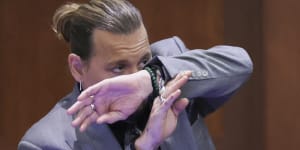 Actor Johnny Depp demonstrates how he claims to have shielded himself from an alleged attack by his ex-wife Amber Heard.