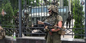 Fighters of Wagner private mercenary group stand guard outside the headquarters of the Southern Military District in the city of Rostov-on-Don on Saturday. 