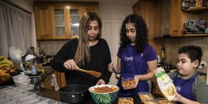 Sherin Fishwick and her children Ameera,13,and Gabriel,7,cooking pasta for the less fortunate.