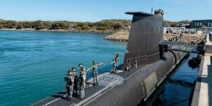 Crew members working on board HMAS Rankin,a Collins-class submarine,at HMAS Stirling in Western Australia.