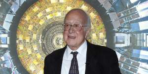 Professor Peter Higgs in front of a photograph of the Large Hadron Collider at the Science Museum,London,2013.