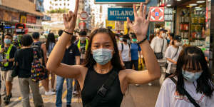 A woman makes a gesture during a protest against the national security law in Hong Kong on June 28. 
